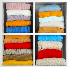 Many knitted winter clothes stacked on shelves on white background