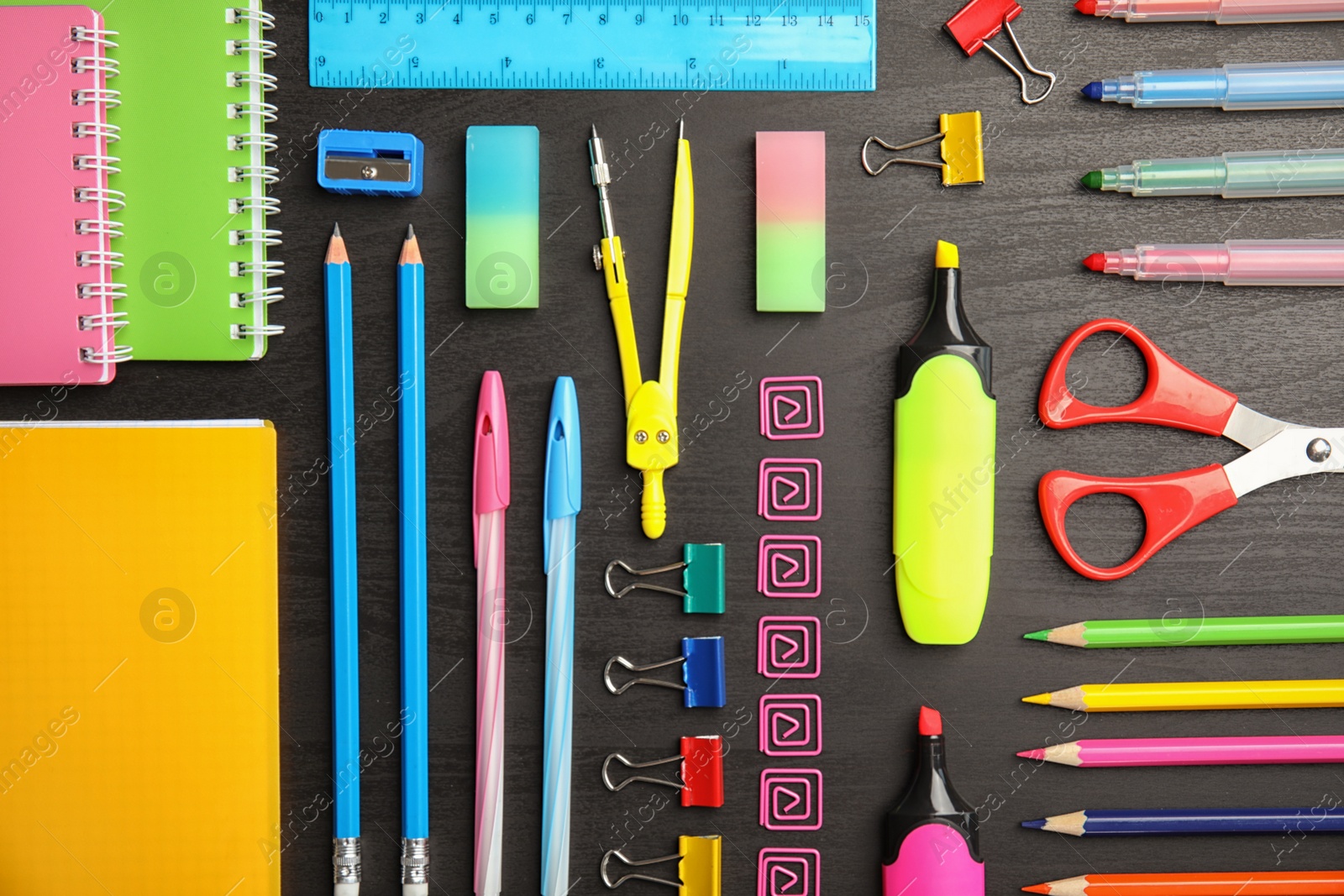 Photo of Different school stationery on wooden background, flat lay