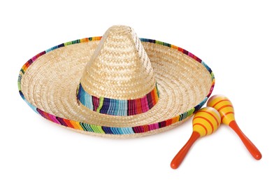 Photo of Mexican sombrero hat and maracas isolated on white