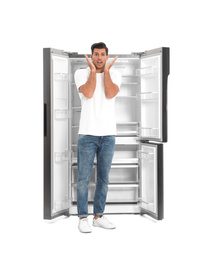 Photo of Man near open empty refrigerator on white background