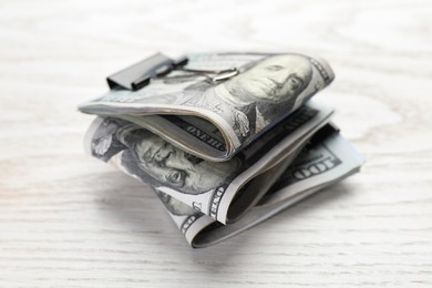 Photo of Many dollar banknotes on white wooden table, closeup. American national currency