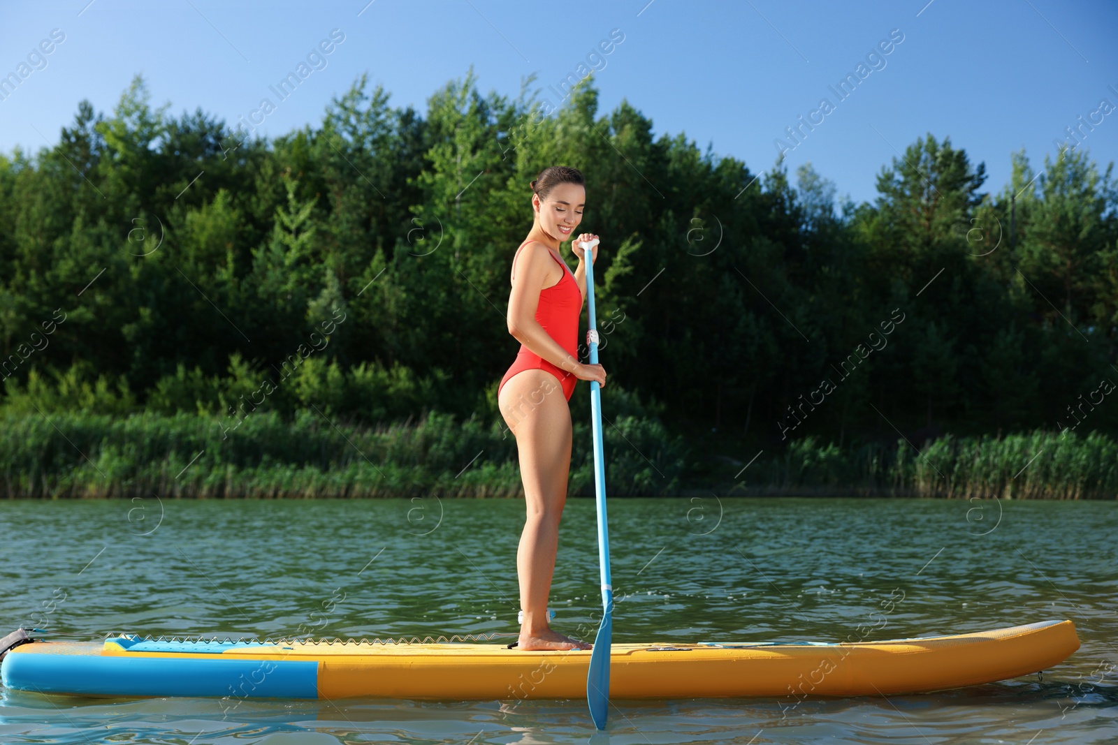 Photo of Woman paddle boarding on SUP board in river