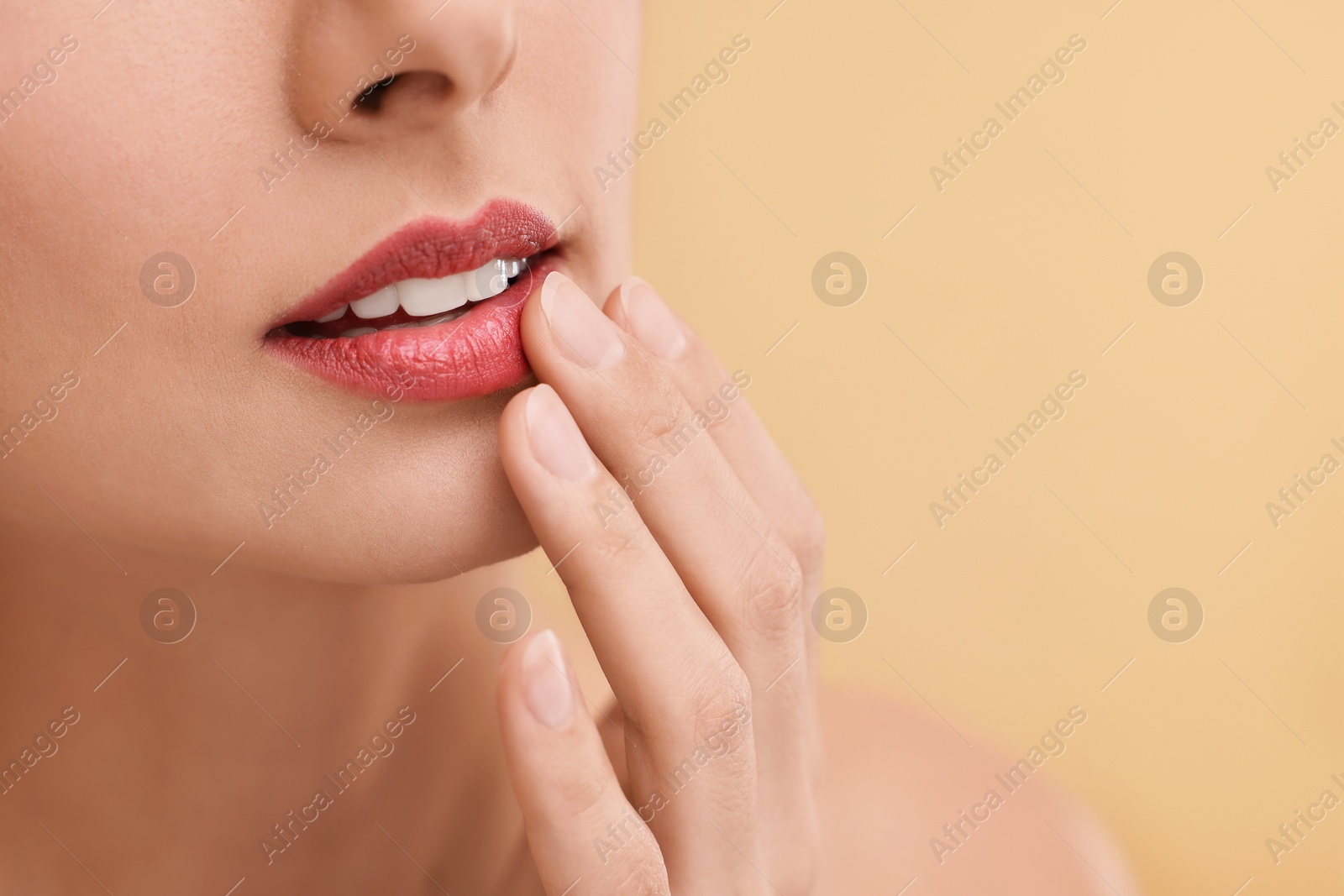 Photo of Woman with beautiful lips on beige background, closeup. Space for text