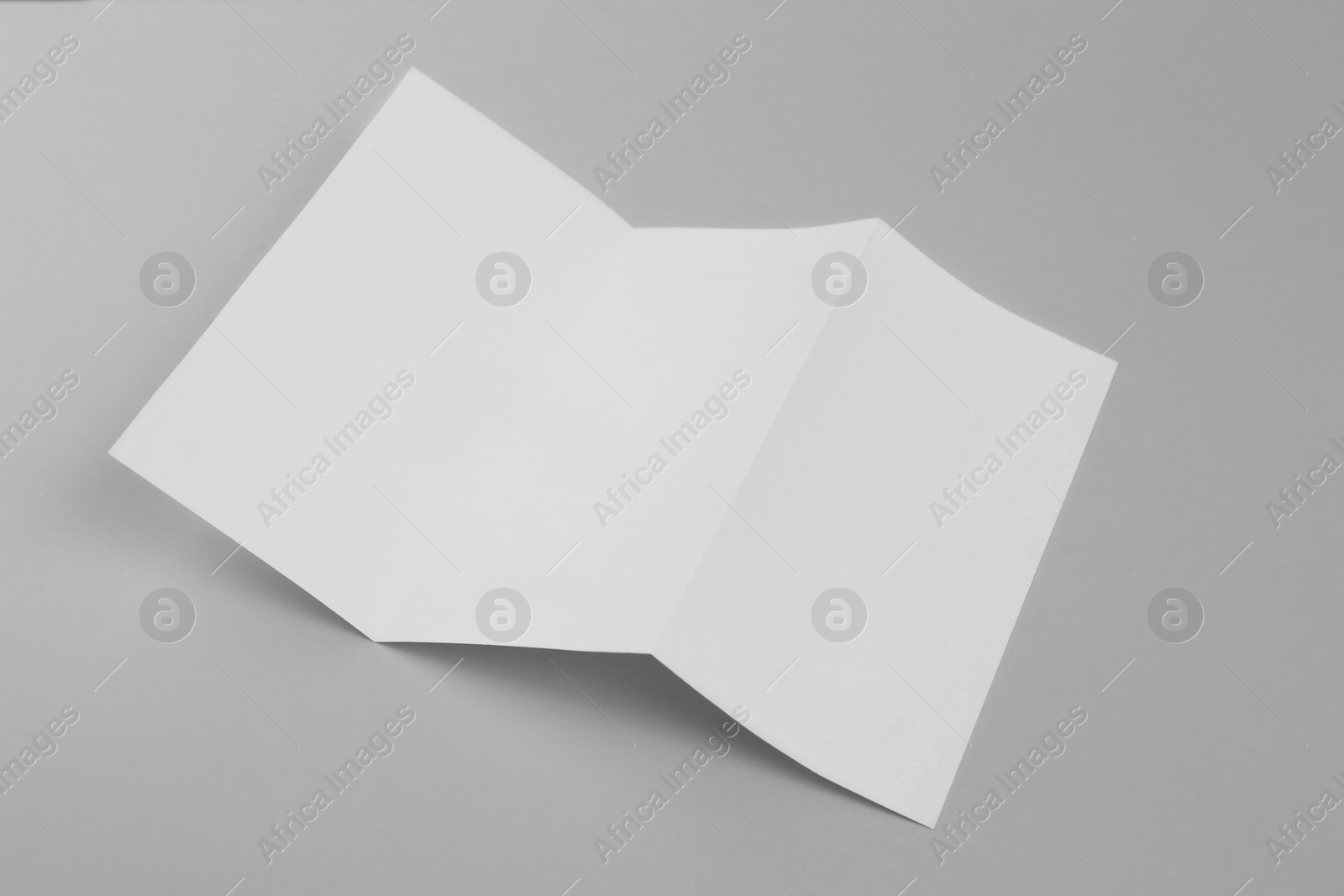 Photo of Blank paper brochure on light grey background. Mockup for design