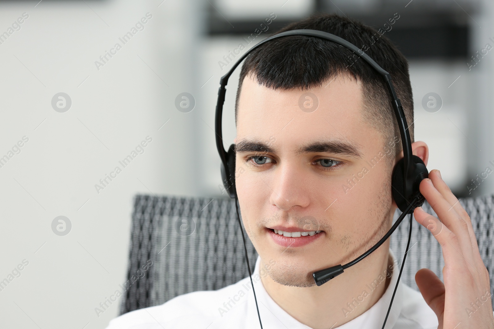 Photo of Hotline operator with headset working in office, space for text