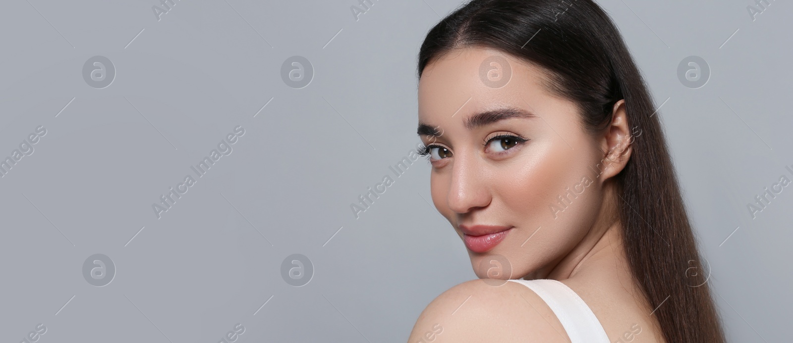 Image of Portrait of beautiful young woman on light grey background. Banner design with space for text