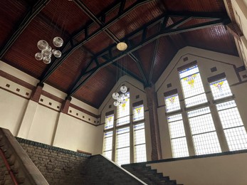 Photo of Lyceum hall with beautiful stained glass windows and modern lamps