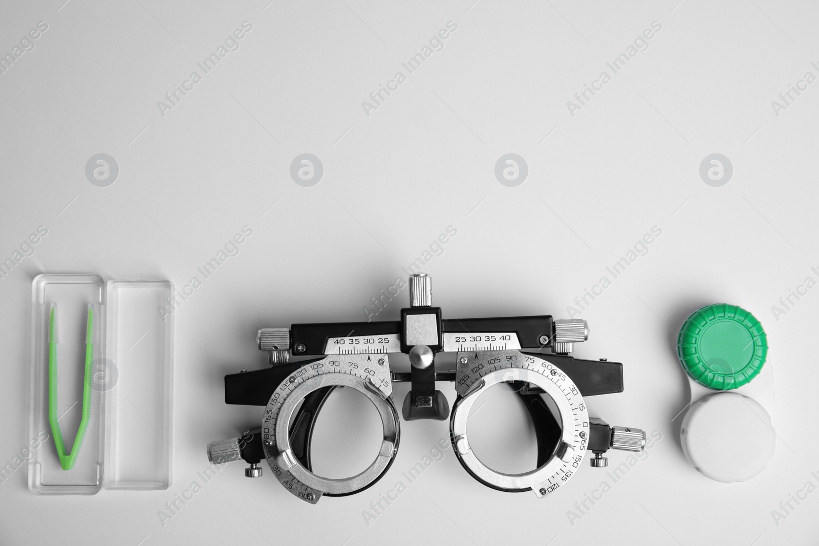 Photo of Different ophthalmologist tools on white background, flat lay