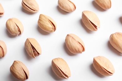 Photo of Organic pistachio nuts in shell on white background