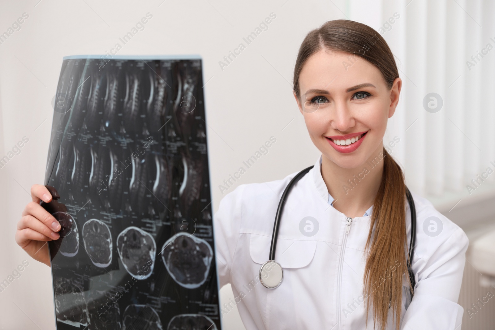 Photo of Professional orthopedist examining X-ray picture in her office
