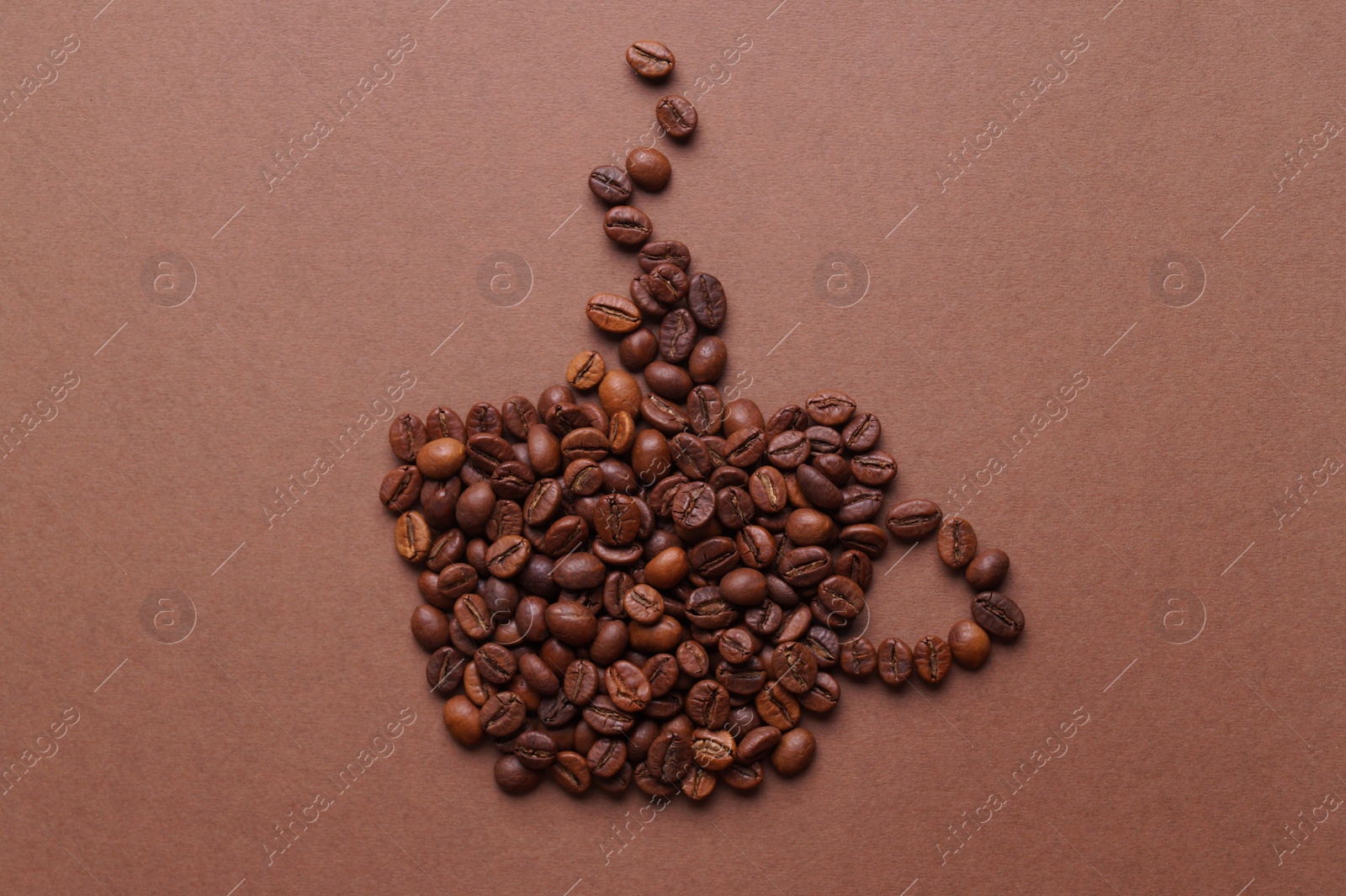 Photo of Cup of hot drink, composition made with coffee beans on brown background, flat lay