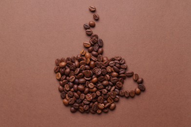 Photo of Cup of hot drink, composition made with coffee beans on brown background, flat lay