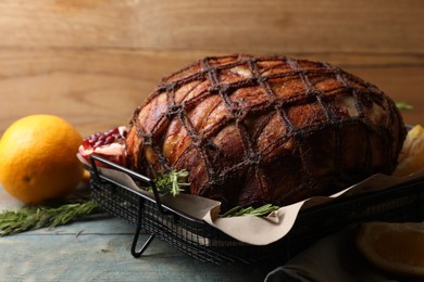 Delicious baked ham and rosemary on rustic wooden table, closeup