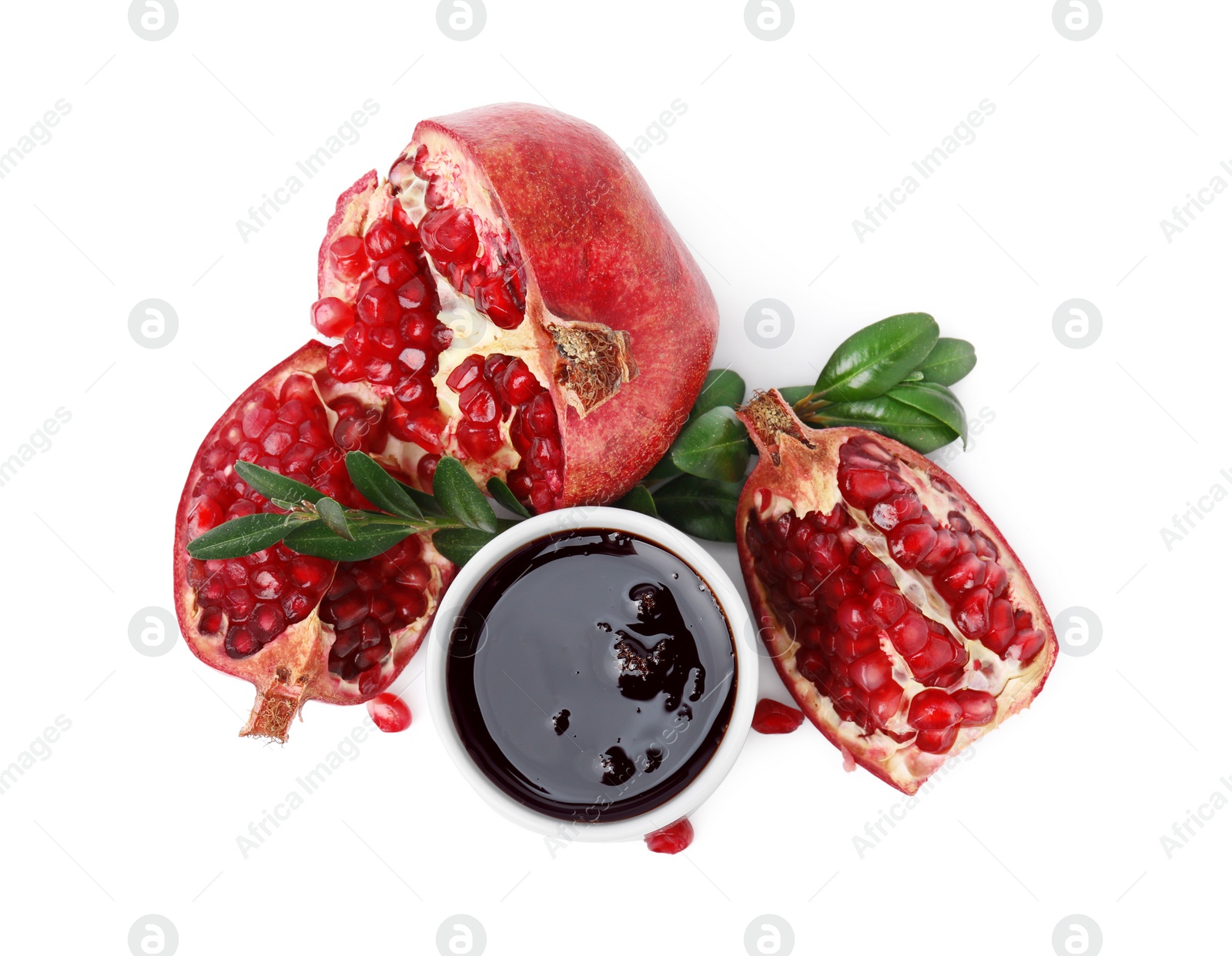 Photo of Tasty pomegranate sauce, fruits and branches isolated on white, top view