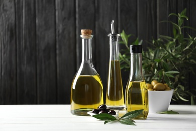 Composition with fresh olive oil on table