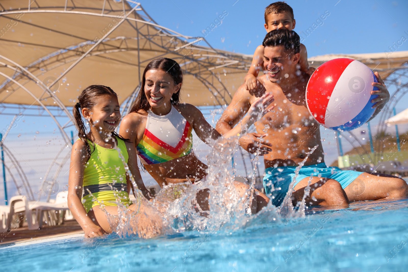 Photo of Happy family having fun at water park. Summer vacation