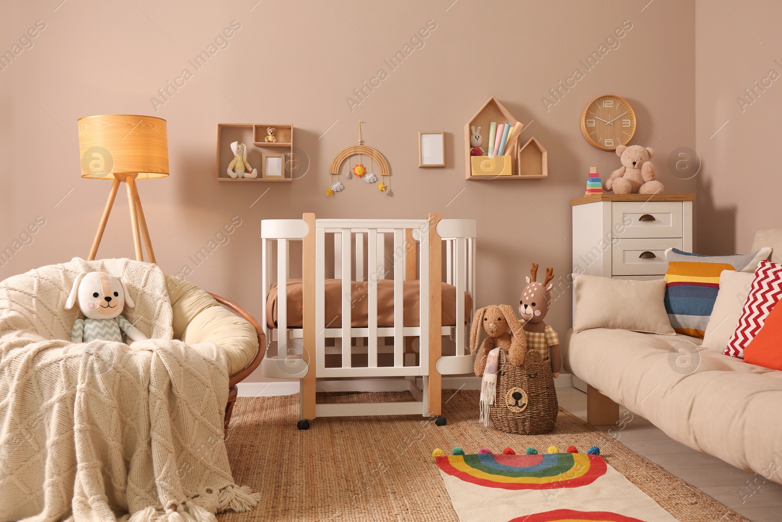 Photo of Baby room interior with stylish furniture and comfortable crib