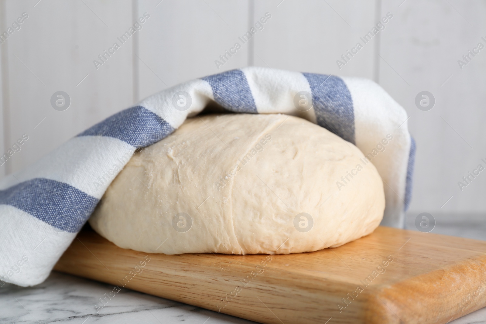 Photo of Fresh yeast dough on white marble table