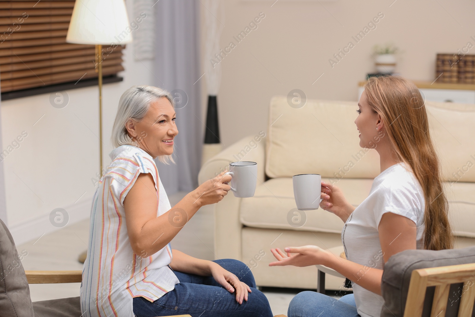 Photo of Mother and her adult daughter spending time together at home