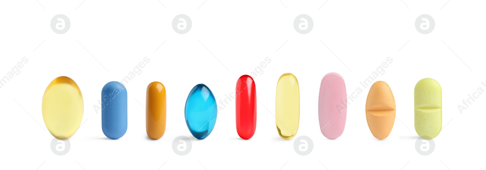 Image of Set of different color pills in row isolated on white