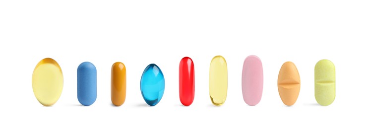 Image of Set of different color pills in row isolated on white