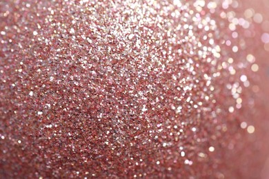 Photo of Beautiful rose gold shiny glitter as background, closeup