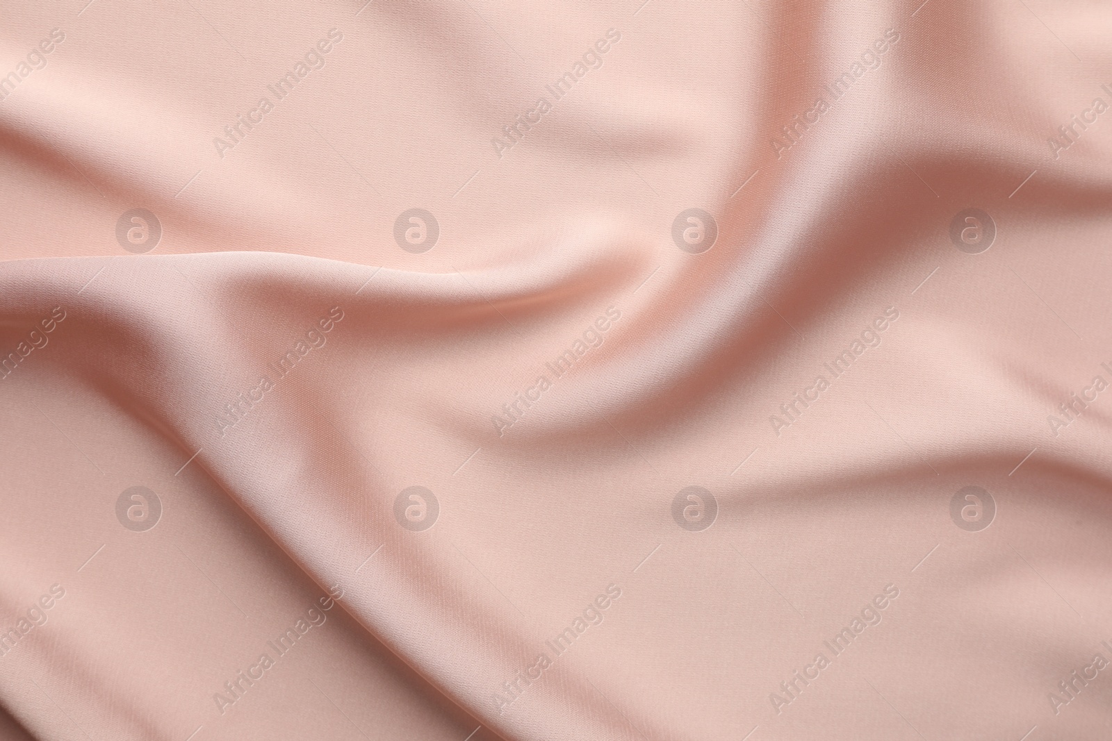 Photo of Crumpled pink silk fabric as background, top view