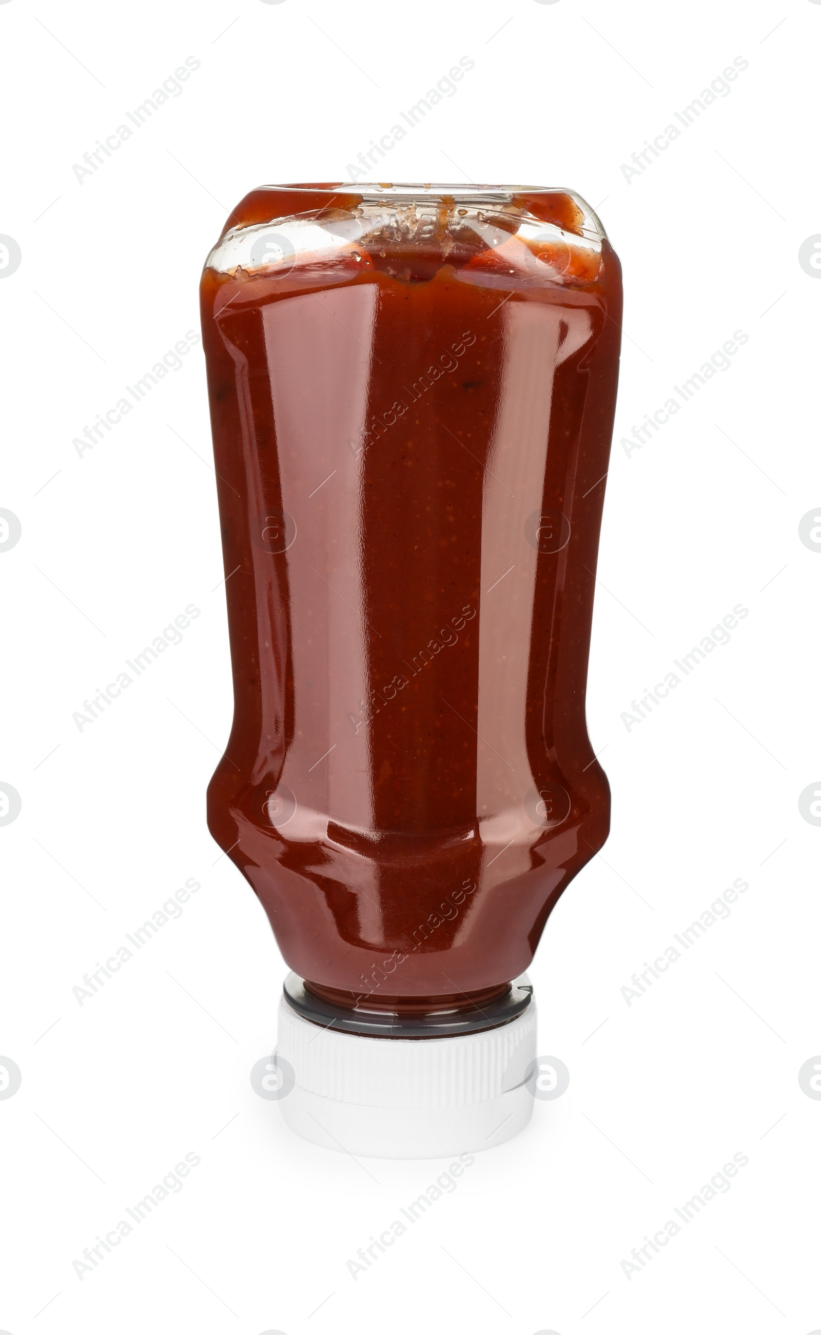 Photo of Bottle of tasty ketchup isolated on white