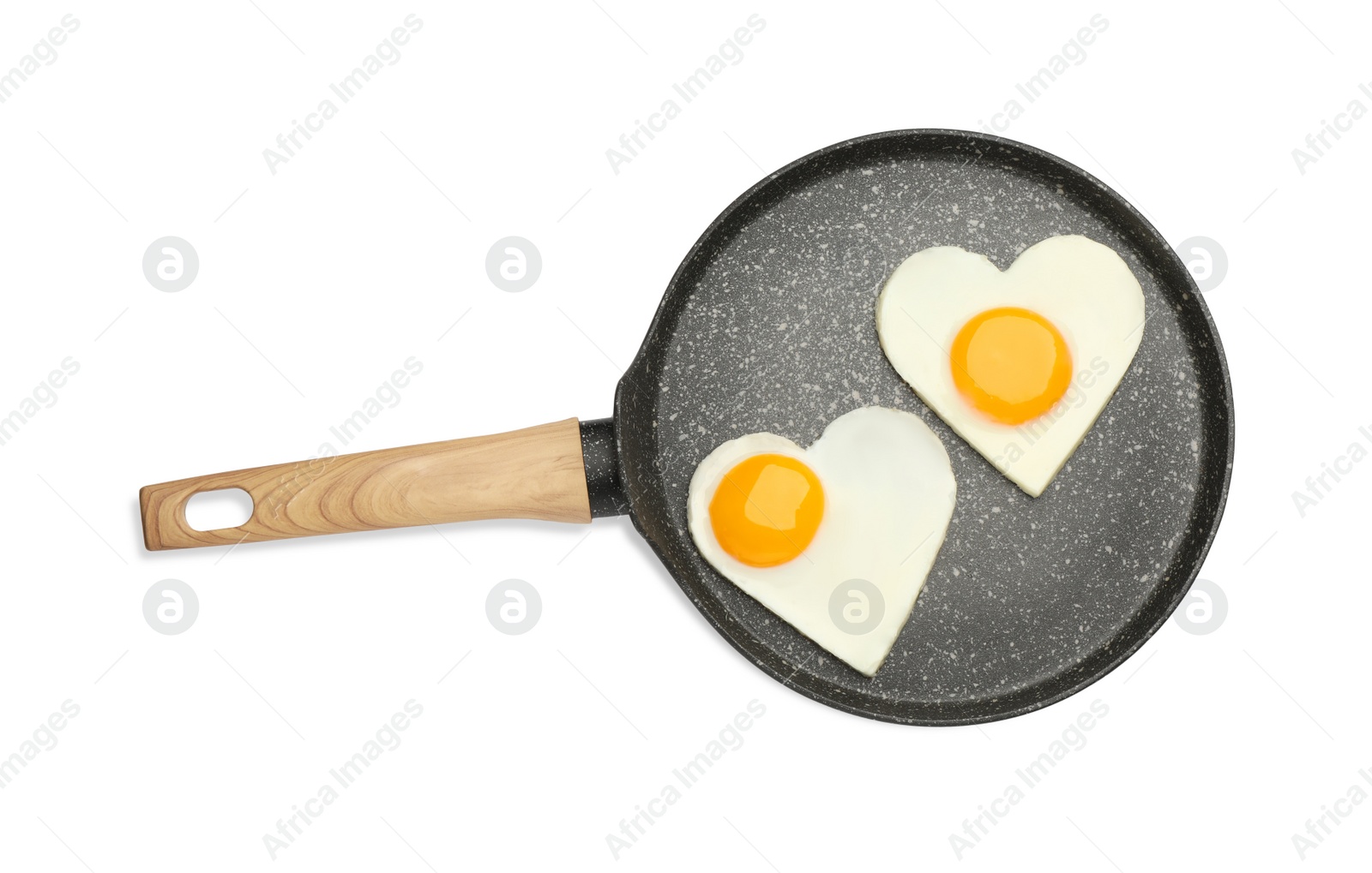 Photo of Heart shaped fried eggs in frying pan isolated on white, top view