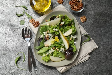 Photo of Fresh salad with pear served on grey table, flat lay