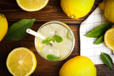 Photo of Cool freshly made lemonade and fruits on wooden table, flat lay