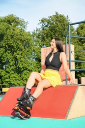 Photo of Woman with kangoo jumping boots sitting in workout park