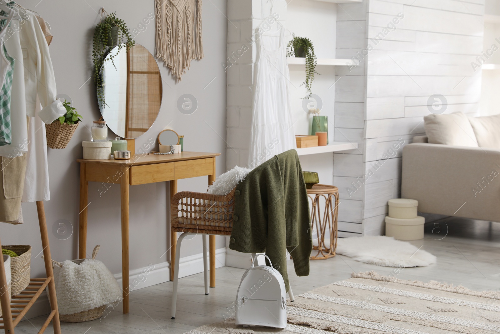 Photo of Wooden dressing table with decorative elements in room. Interior design