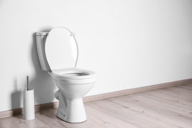 Photo of New ceramic toilet bowl in modern bathroom