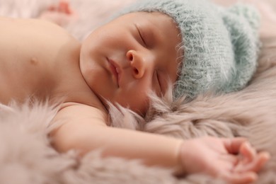 Cute newborn baby sleeping on fluffy blanket, closeup