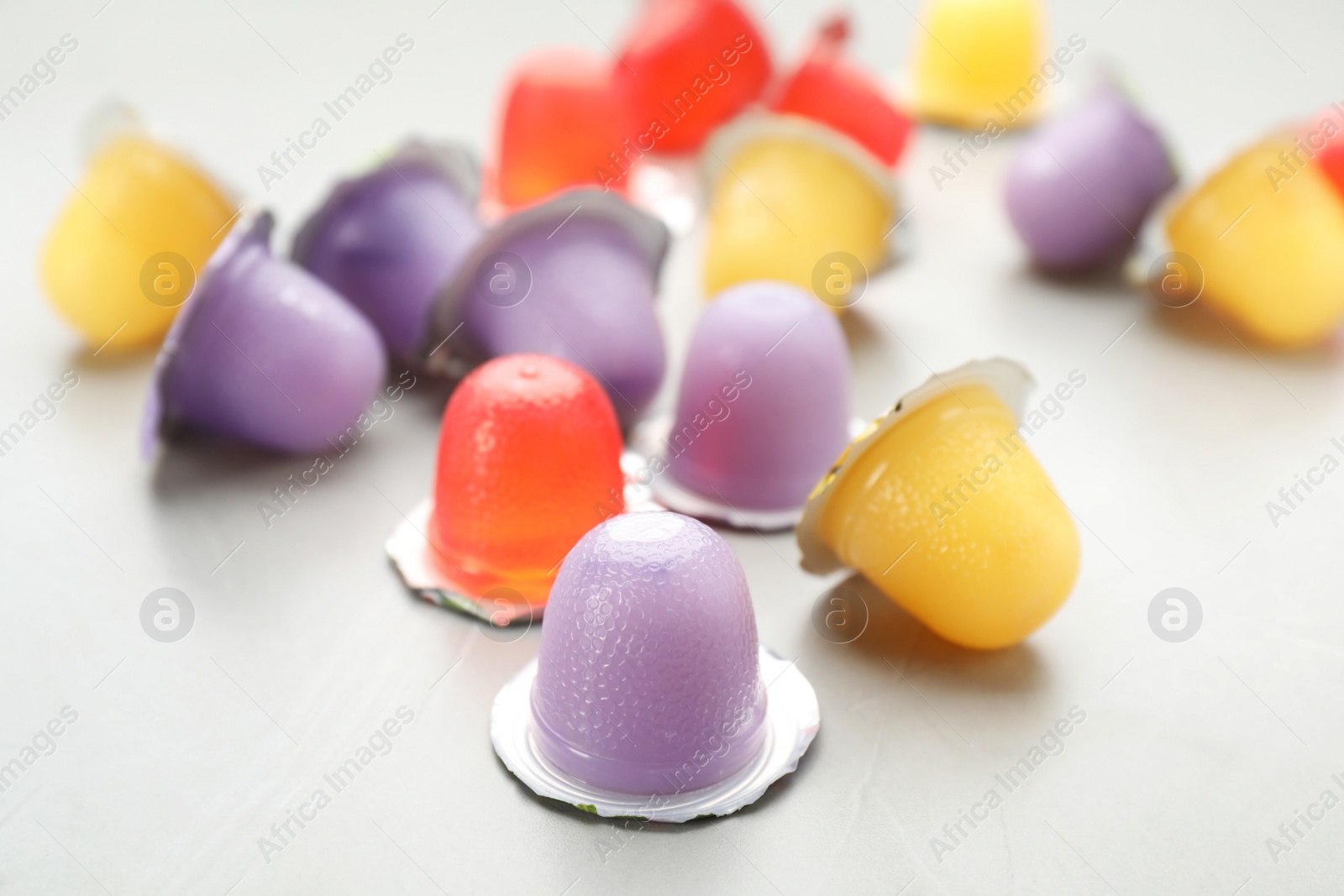 Photo of Tasty bright jelly cups on light table