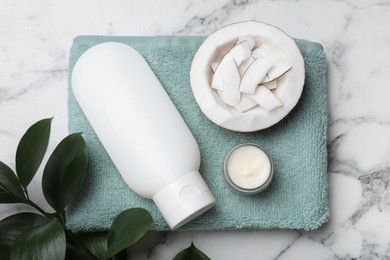 Body cream and cosmetic product, coconut with towel on white marble table, flat lay