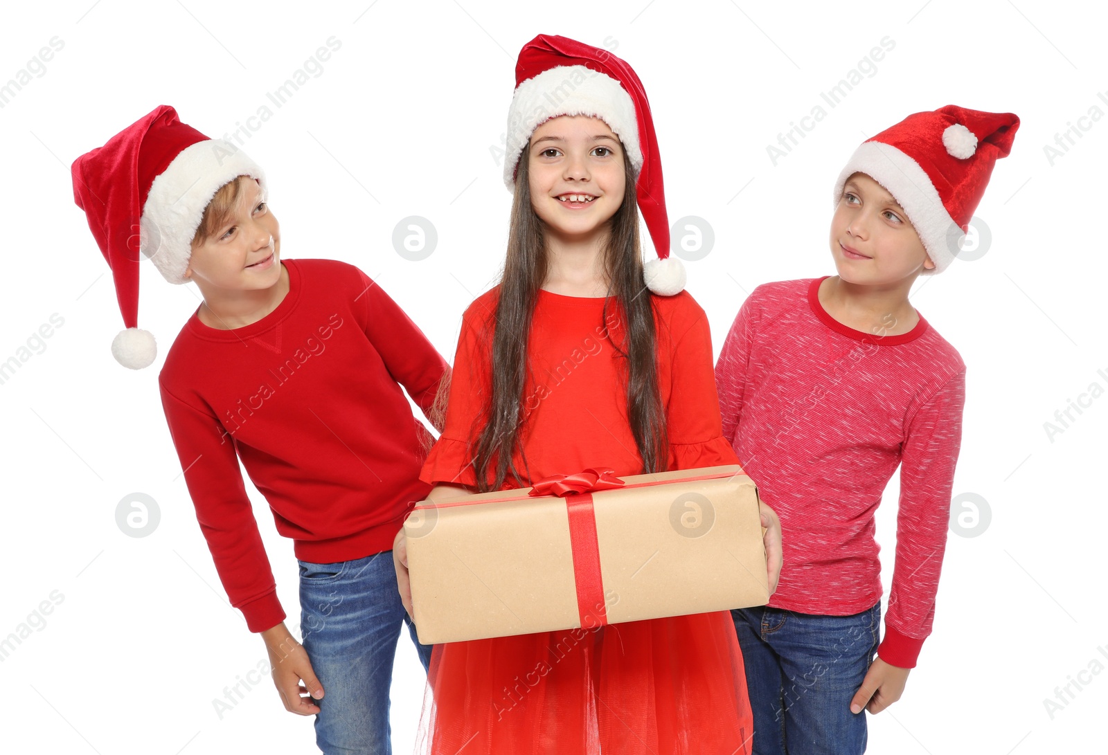 Photo of Cute little children in Santa hats with Christmas gift box on white background