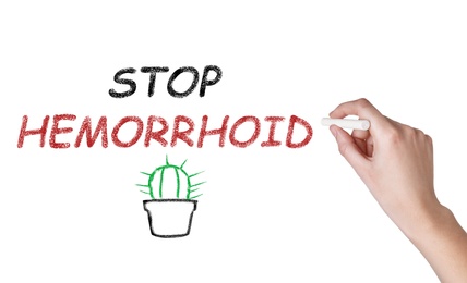 Image of Woman writing phrase Stop Hemorrhoid on white background, closeup