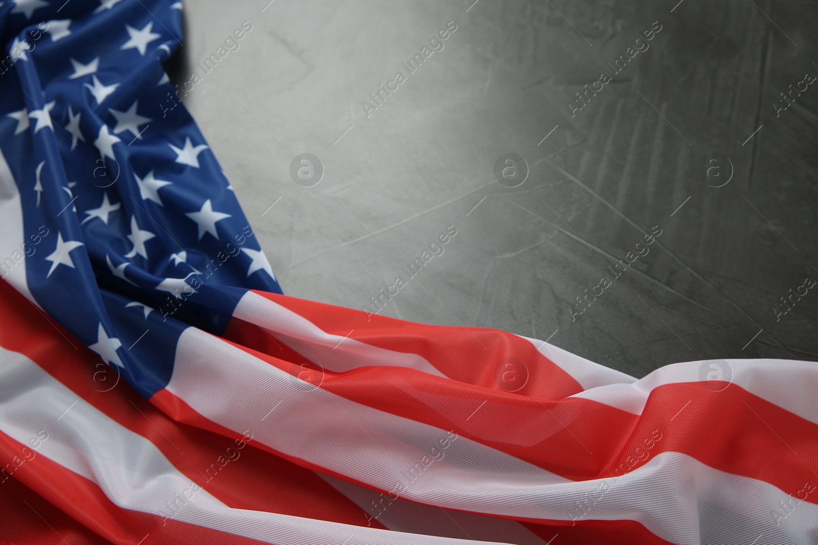 Photo of Flag of USA on black table, closeup. Space for text