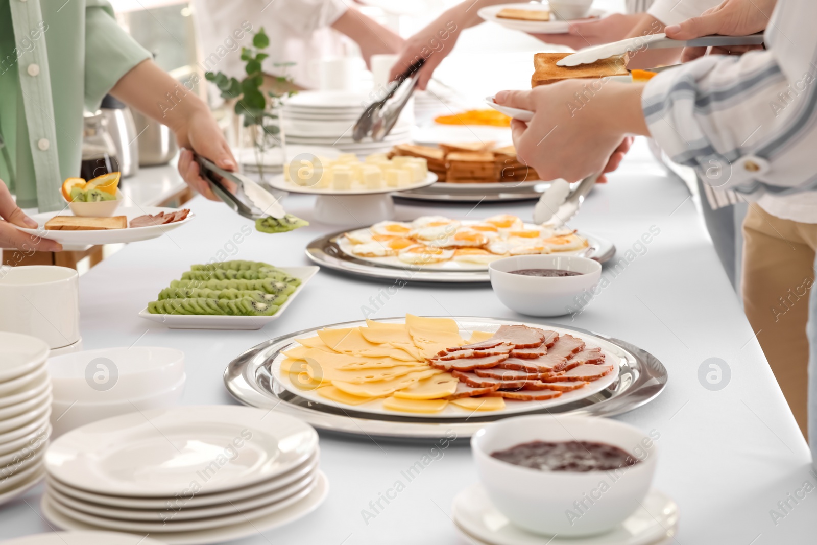 Photo of People taking food during breakfast, closeup. Buffet service