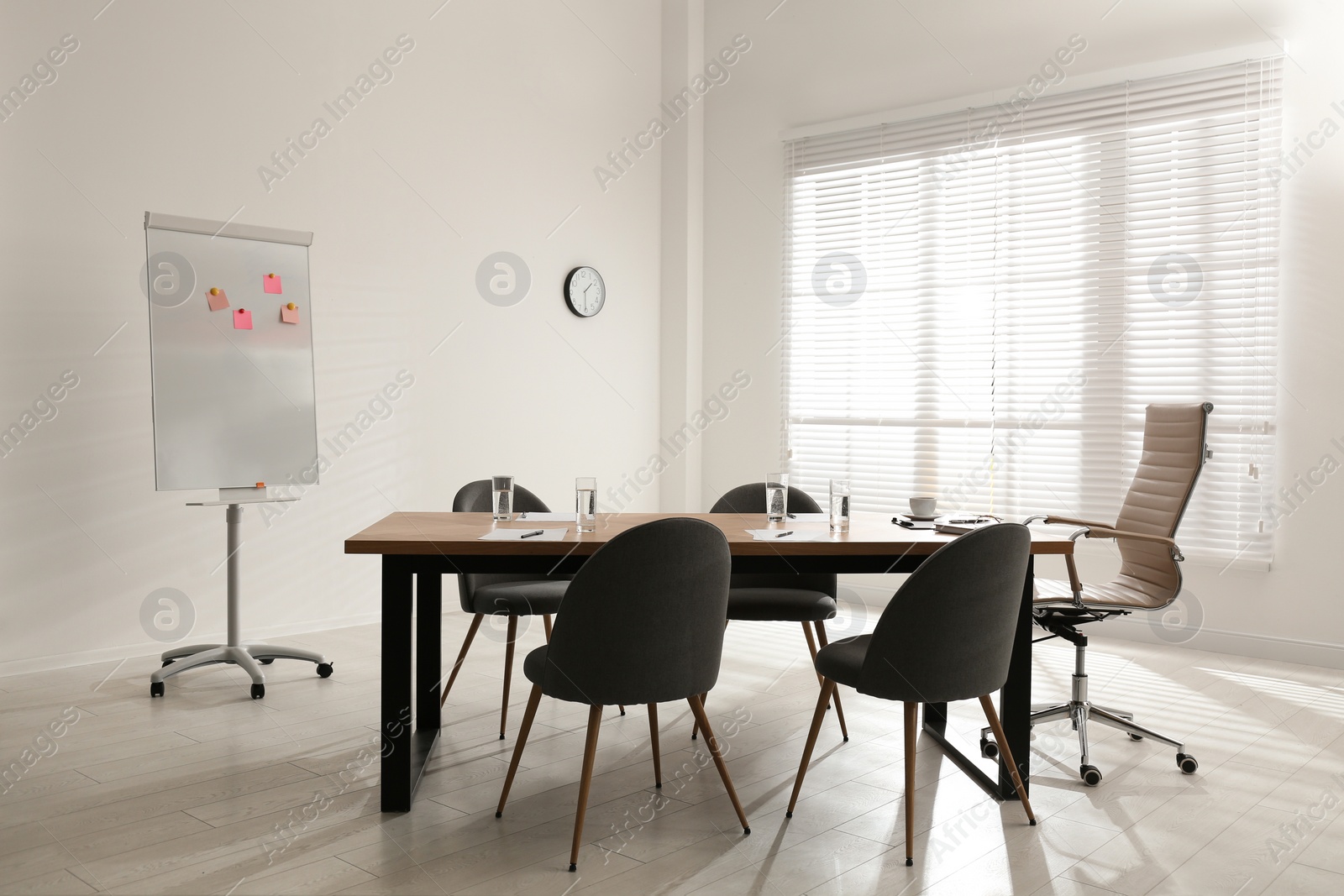 Photo of Simple office interior with large table and chairs