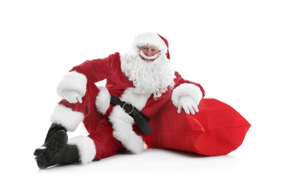 Photo of Authentic Santa Claus with big red bag full of gifts sitting on white background