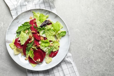 Plate with delicious beet salad on grey background, top view