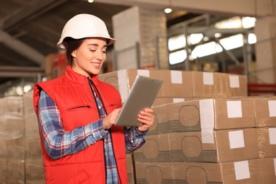 Image of Woman with tablet working at warehouse. Logistics center