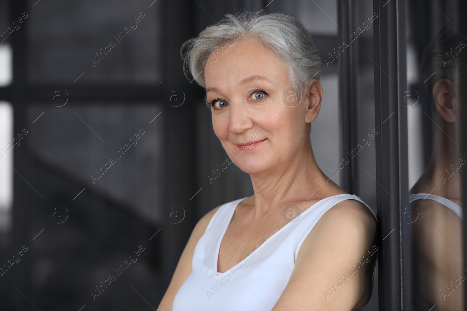 Photo of Portrait of happy mature woman indoors, space for text. Smart aging