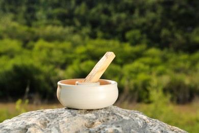 Palo santo stick on stone surface outdoors