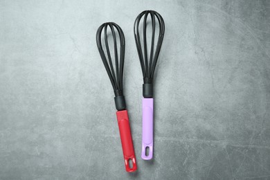 Photo of Two whisks on gray table, top view