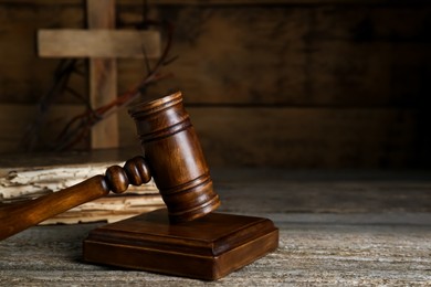 Photo of Judge gavel on old wooden table. Space for text