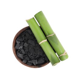 Photo of Fresh bamboo and charcoal on white background, top view